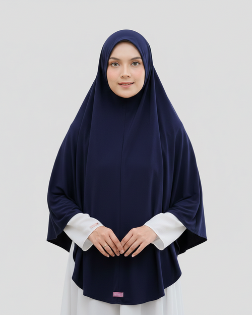 Woman wearing a navy hijab and white shirt on a light gray background